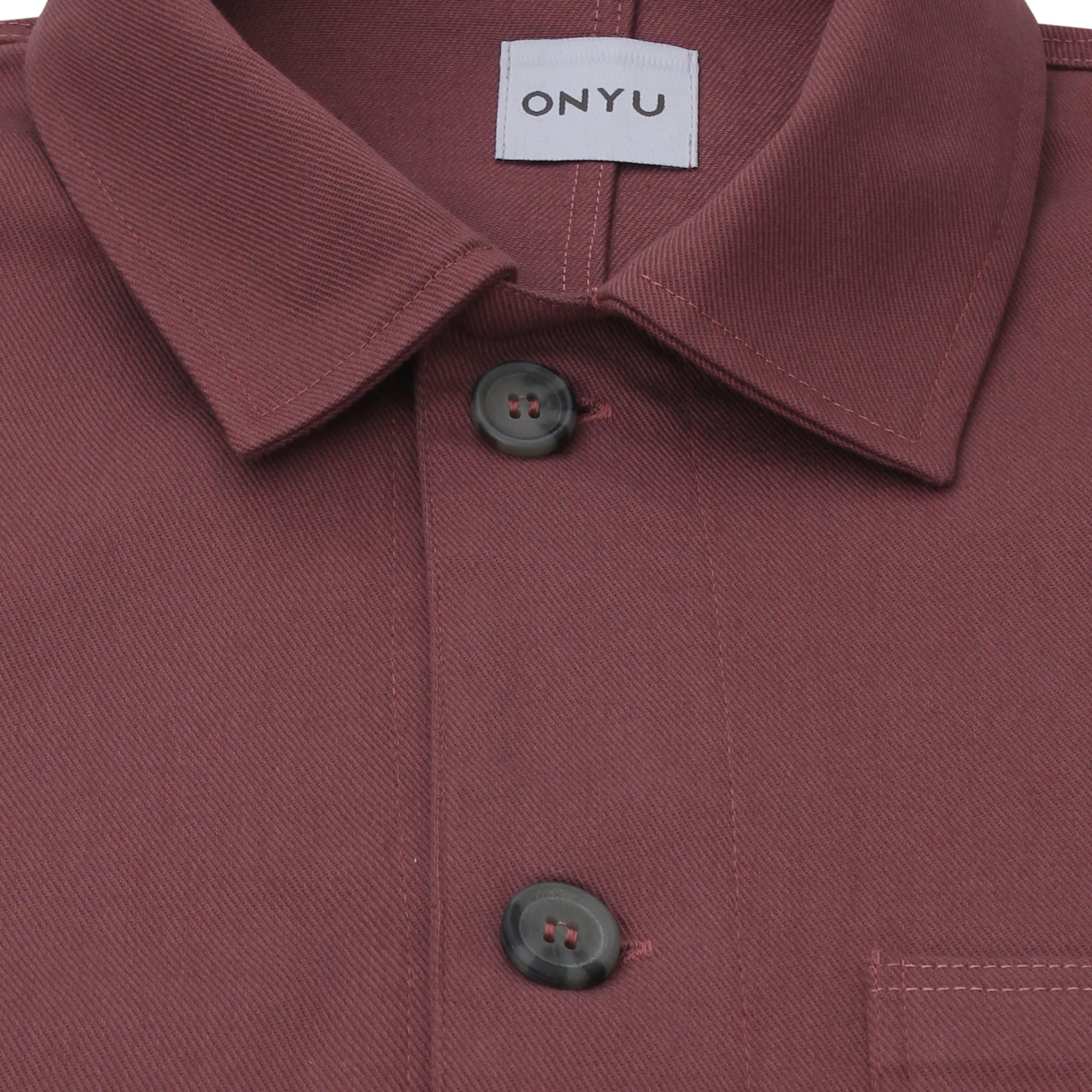 Close-up of a maroon shirt with a collar and buttons, featuring the 'ONYU' brand label.
