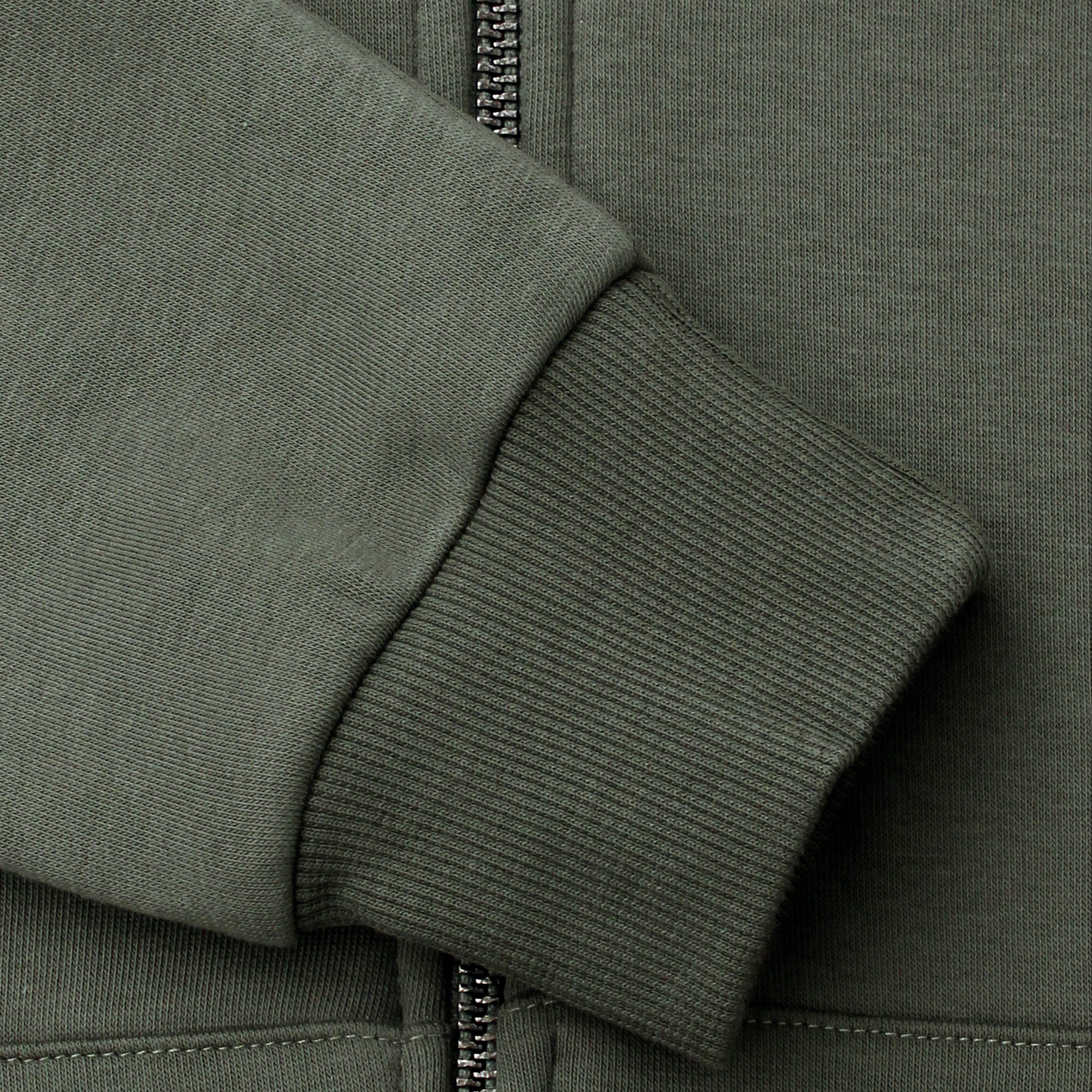 Close-up of a green hoodie with a zipper and drawstring.